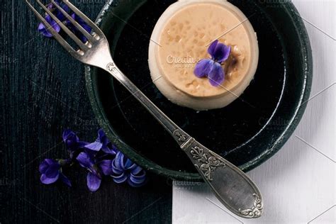 Caramel Pannacotta With Violet Flowers Featuring Panna Cotta And