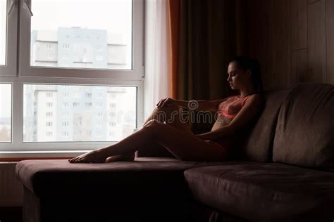 Sensual Naked Woman In Lingerie Lying On Bed In Room Stock Image