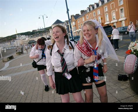 Laughing Adult Women Dressed As Naughty Schoolgirls On Hen Night Party