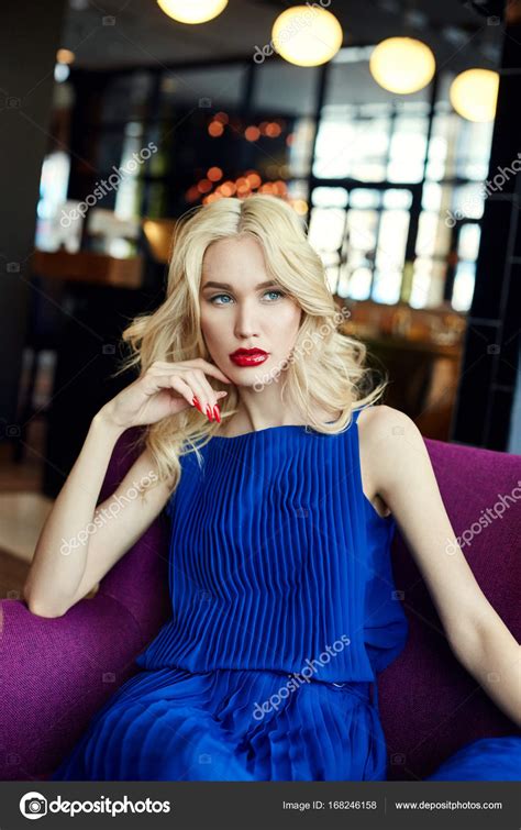 Sexy Blonde In Blue Dress Sitting In A Chair In The Restaurant Perfect Makeup Skin Care