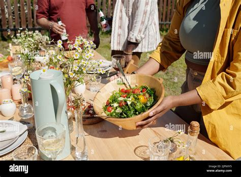 Young Black Woman Serving Table With Homemade Food Drinks Wildflowers