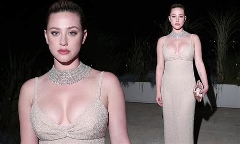 Lili Reinhart Puts On A VERY Busty Display In A Sparkling Nude Diamante Dress As She Attends The