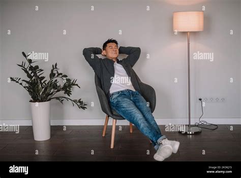 Satisfied Happy Mature Chinese Man Relaxing With Closed Eyes Enjoy
