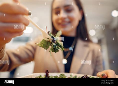 Girl Eats Vegetable Salad Lady Sitting In A Cafe Brunette In A Brown Coat Stock Photo Alamy