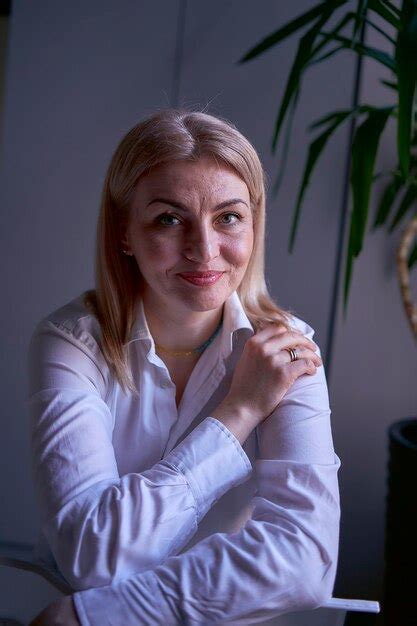 Premium Photo Portrait Of A Blonde Woman In Jeans And A White Shirt In The Office