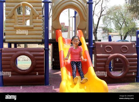 Year Old Latin Brunette Girl With Eyeglasses Plays On The Park Playground Slide Alone Due To