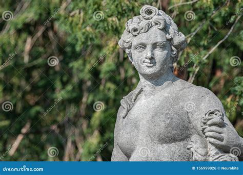 Old Statue Of A Sensual Naked Renaissance Era Woman During Bathing In Park Of Potsdam Germany