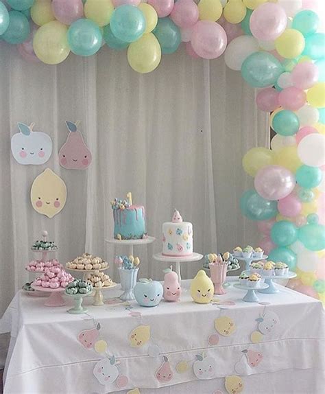 A Table Topped With Lots Of Cake And Balloons