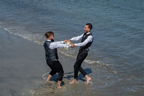Romantic Men Same Sex Marriage Gay Grooms Walking Together On Sea Beach During Wedding Day