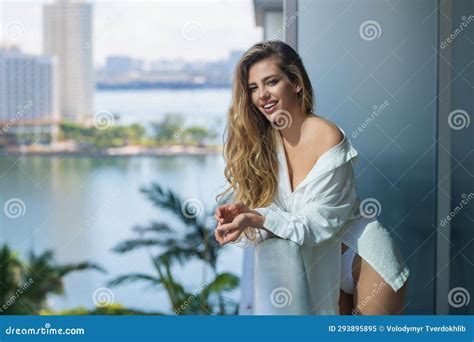 Woman On The Balcony Enjoying City View Attractive Girl With Long Blonde Hair In Shirt On