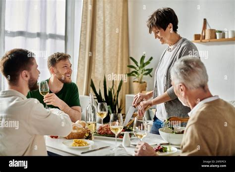 A Gay Couple Enjoys Dinner With Parents At Home Stock Photo Alamy