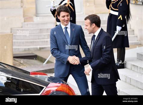 The President Of The Republic Emmanuel Macron Welcoming The Canadian