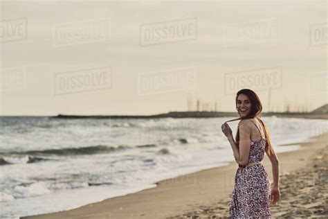 Happy Brunette Woman In Summer Dress In The Beach At Golden Hour Stock Photo Dissolve