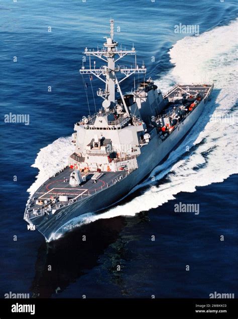 An aerial port bow view of the guided missile destroyer USS Carney (DDG