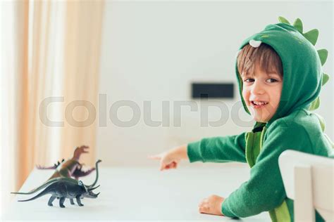 kid playing with toy dinosaurs | Stock image | Colourbox
