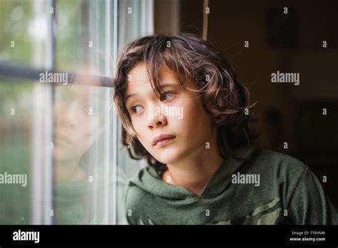 boy gazes   window   expression   face stock