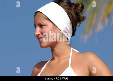 Sexy Colombian Woman In Bikini And Wearing White Sun Glasses And Red Lipstick Practices Yoga On