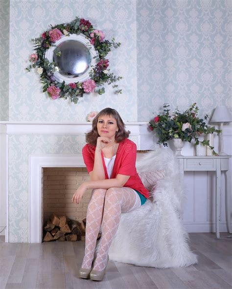 Blonde Model In White Stockings And Green Miniskirt Posing In Studio Stock Image Image Of