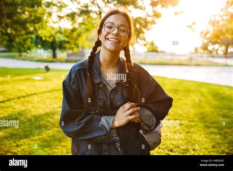 Image Of Laughing Girl Student Wearing Denim Jacket Standing And