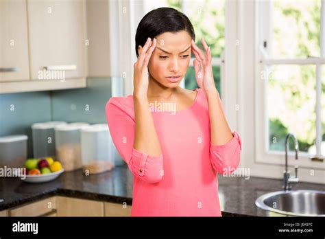 Frowning Brunette With Hands On Face Stock Photo Alamy