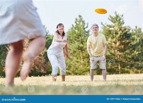 Group Of Senior Citizens Playing Frisbee Stock Photo Image Of Smile