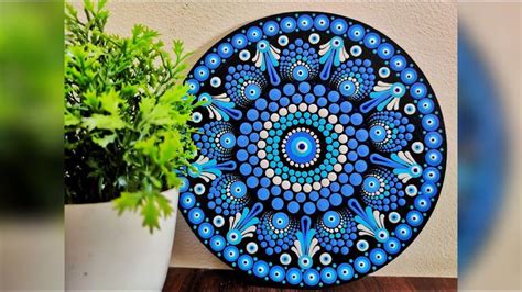 A Blue Plate Sitting On Top Of A Table Next To A Potted Plant