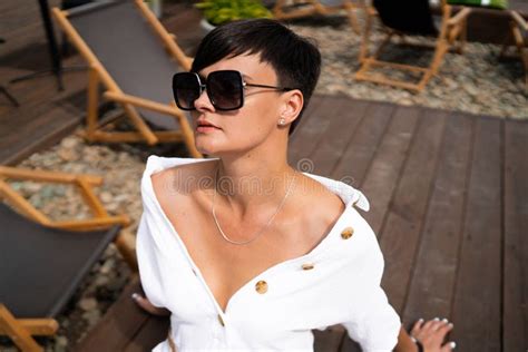 Beautiful Woman With Short Brunette Hair In White Clothes And Sunglasses Fashion Street