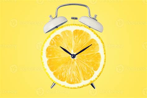 creative concept clock  lemon dial  yellow background