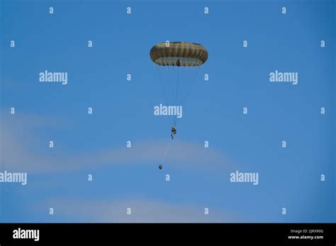 British Army Paratrooper Preparing To Move Out From An Airborne Assault