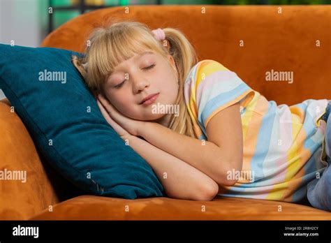 Tired Preteen School Girl Lying Down In Bed Taking A Rest At Home On Couch Carefree Blonde