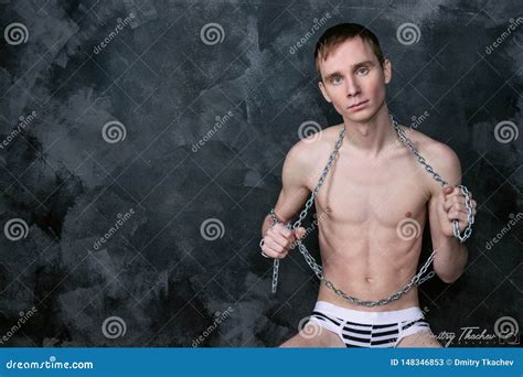 Handsome Naked Skinny Guy Holding A Chain Black Background Stock Image