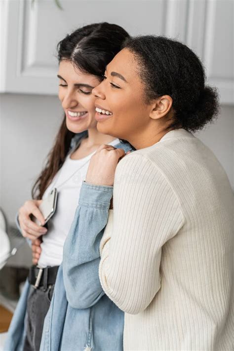 Overjoyed Lesbian Woman Holding Smartphone And Stock Photo Image Of