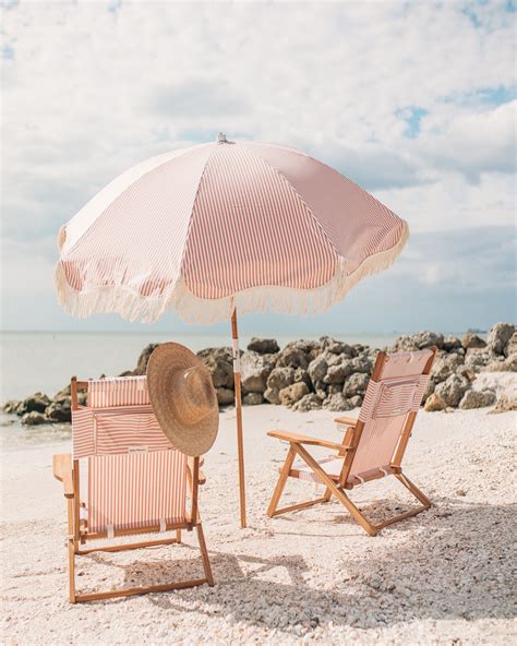 Pink Beach Set With Striped Chairs And Umbrella