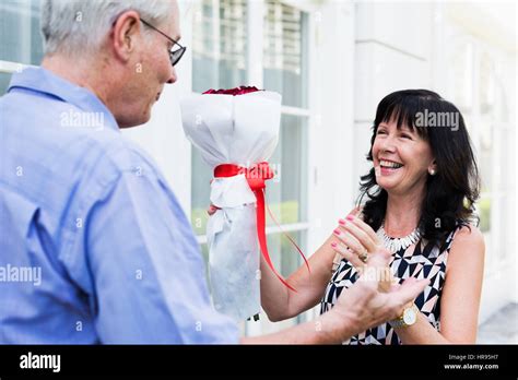 Mature Couple Woman Bouquet Of Flowers Stock Photo Alamy