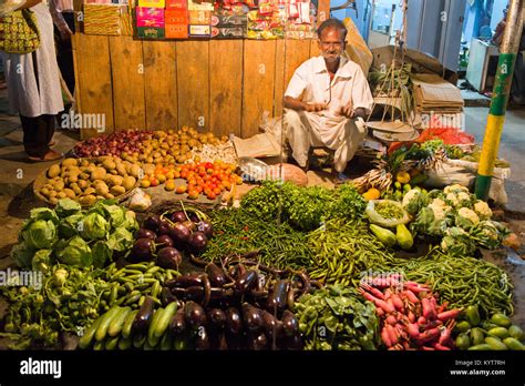 A vendor is selling vegetables and spices on the night market of Tezpur in Arunachal Pradesh ...