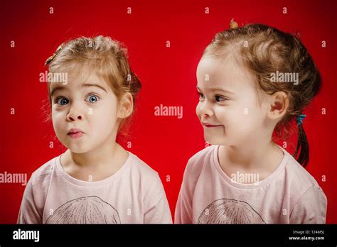 Two Beautiful Twin Sisters Are Making Funny Faces Stock Photo Alamy