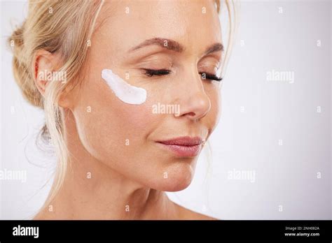 Skincare Face Cream And Mature Woman In Studio For Wellness Beauty And Dermatology On Grey