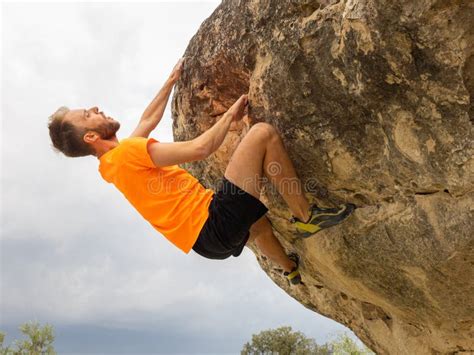 Rock Climber Bouldering Outdoors On Mountain In Nature Stock Photo