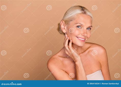 Photo Of Shiny Charming Woman Naked Shoulders Hand Arm Cheek Cheekbone Empty Space Beige Color