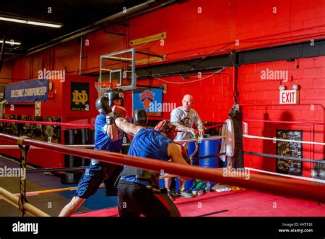 Amateur Boxers Wearing Protective Headgear Sparring In A Gym While