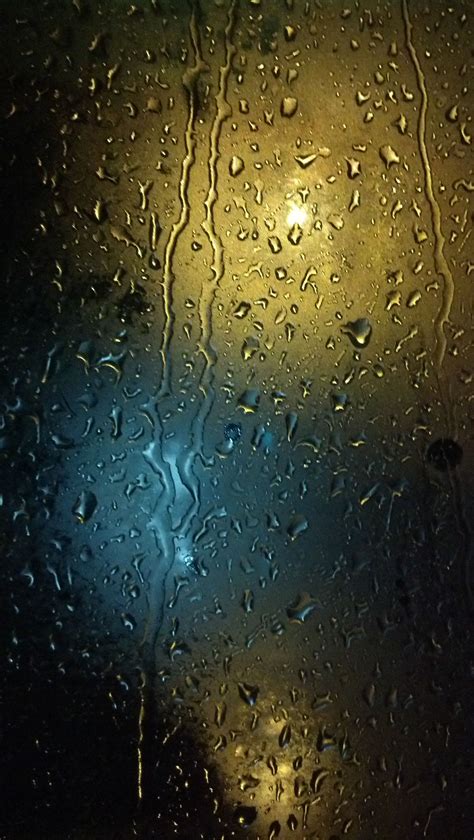 City's Rainy Night: Colorful City Lights Through Raindrops