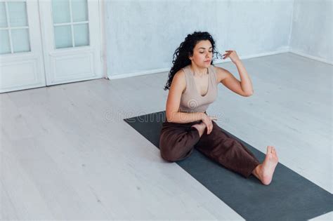 Brunette Woman Doing Gymnastics Yoga Asana On The Floor Stock Photo Image Of Yoga Healthy