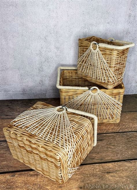 two wicker baskets sitting on top of a wooden table next to each other ...