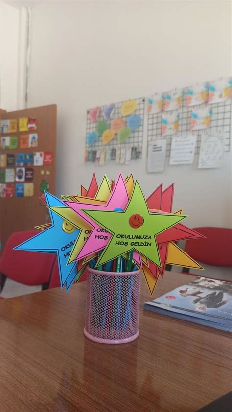 A Vase Filled With Colorful Paper Stars On Top Of A Wooden Table