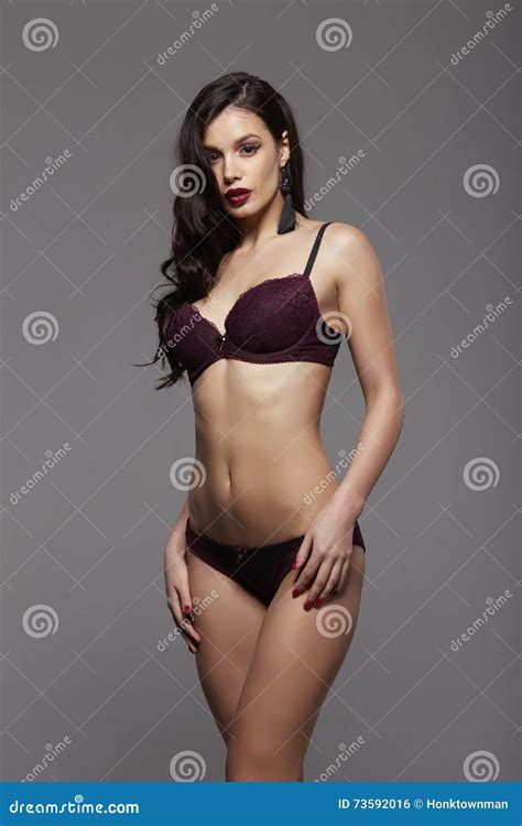 Fashion Brunette Woman With Long Dark Hair And Red Lips In Vinous Lace Lingerie And Black