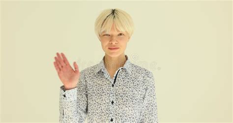 Blonde Female Person Waves Hand To Greet And Smiles Nicely Stock Footage Video Of Blonde