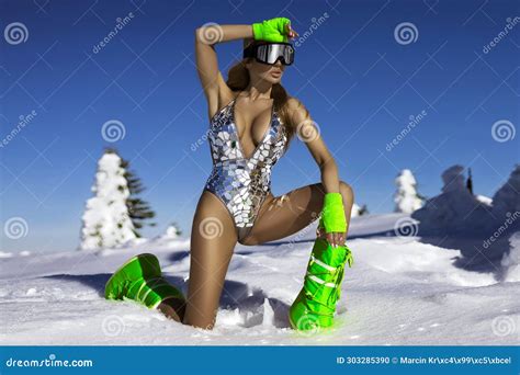 Blonde Girl Wearing Glamour Sequin Silver Mirror Bikini And Winter Fashionable Boots Is Posing