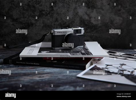 Olympus Trip Vintage Camera In Still Life Image On Stack Of Photo Books