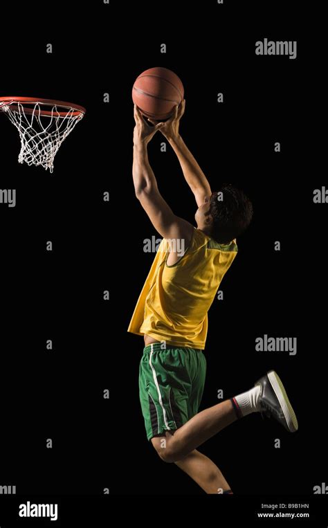 Basketball player shooting the basket Stock Photo - Alamy