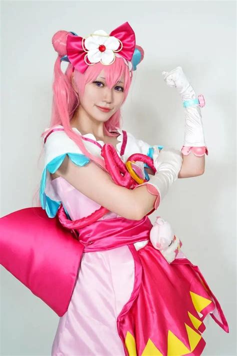 A Woman Dressed In Pink And Yellow Is Posing For The Camera